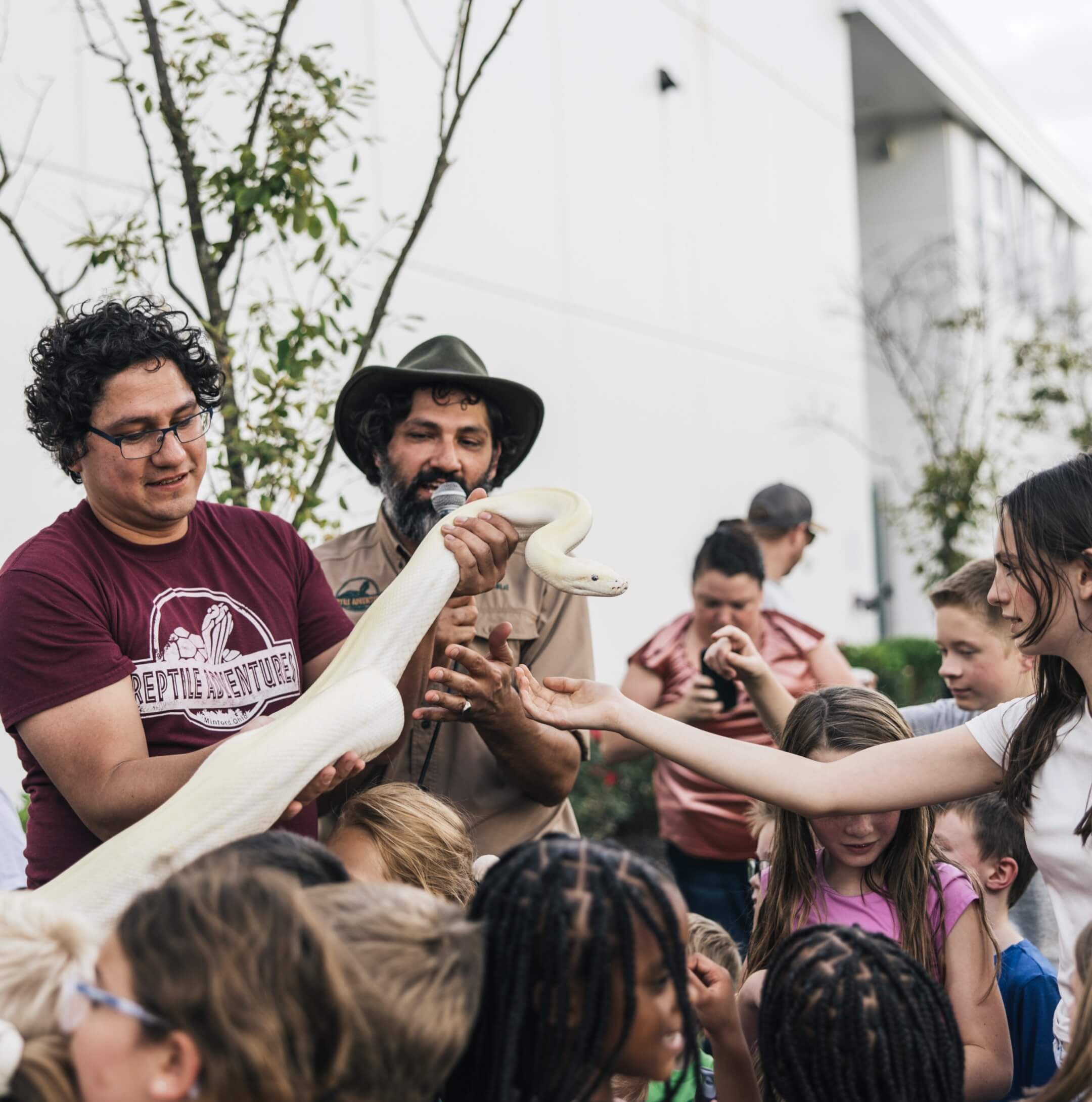 Family enjoying a mobile reptile show